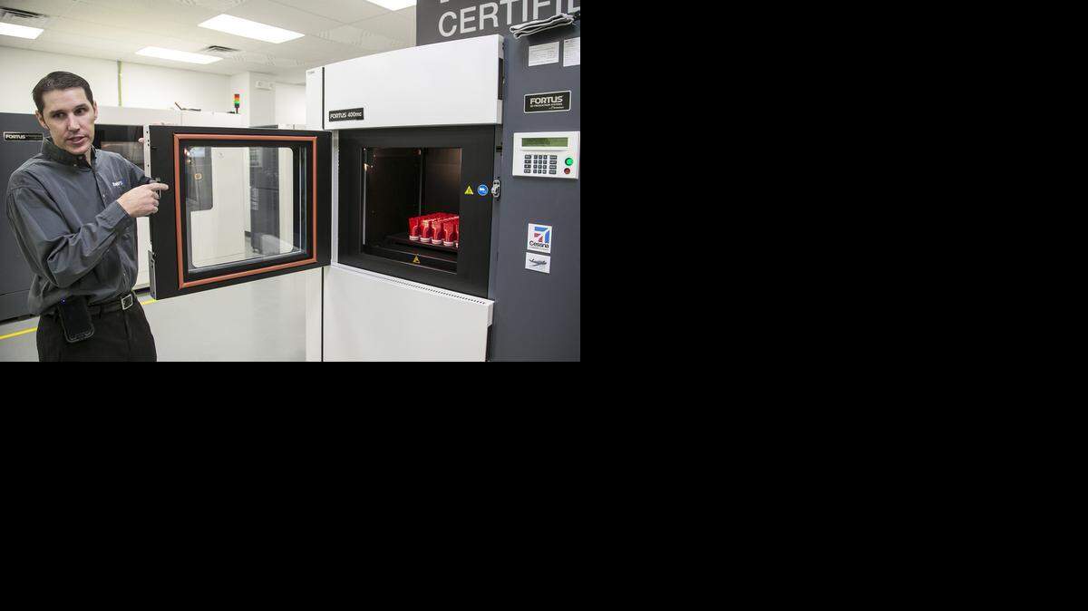 
RapidPSI vice president Jeremy Weinman shows his company's industrial 3D printers. 

