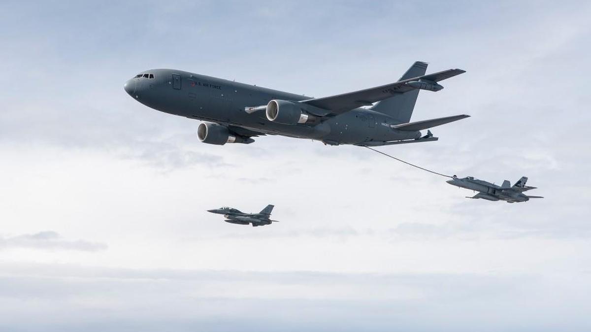 A Boeing KC-46 air refueling tanker uses a centerline hose and drogue to refuel an F/A-18 Super Hornet during a test flight.