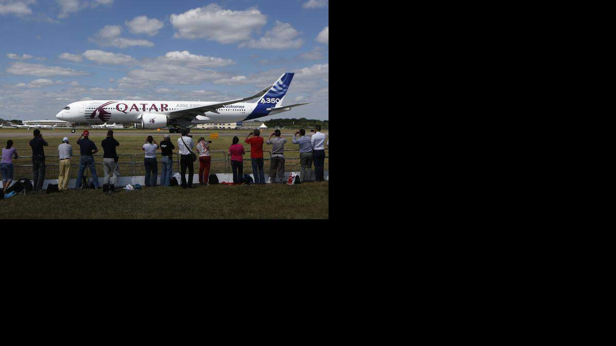 
Visitors watch an Airbus A350 XWB take off for a flying display during the Farnborough International Air Show in England in July. Airbus and Boeing both had their newest wide-body models on display at Farnborough as they competed for sales. Thursday, Delta Airlines confirmed it had chosen to order 50 Airbus planes, rather than Boeing airliners.
