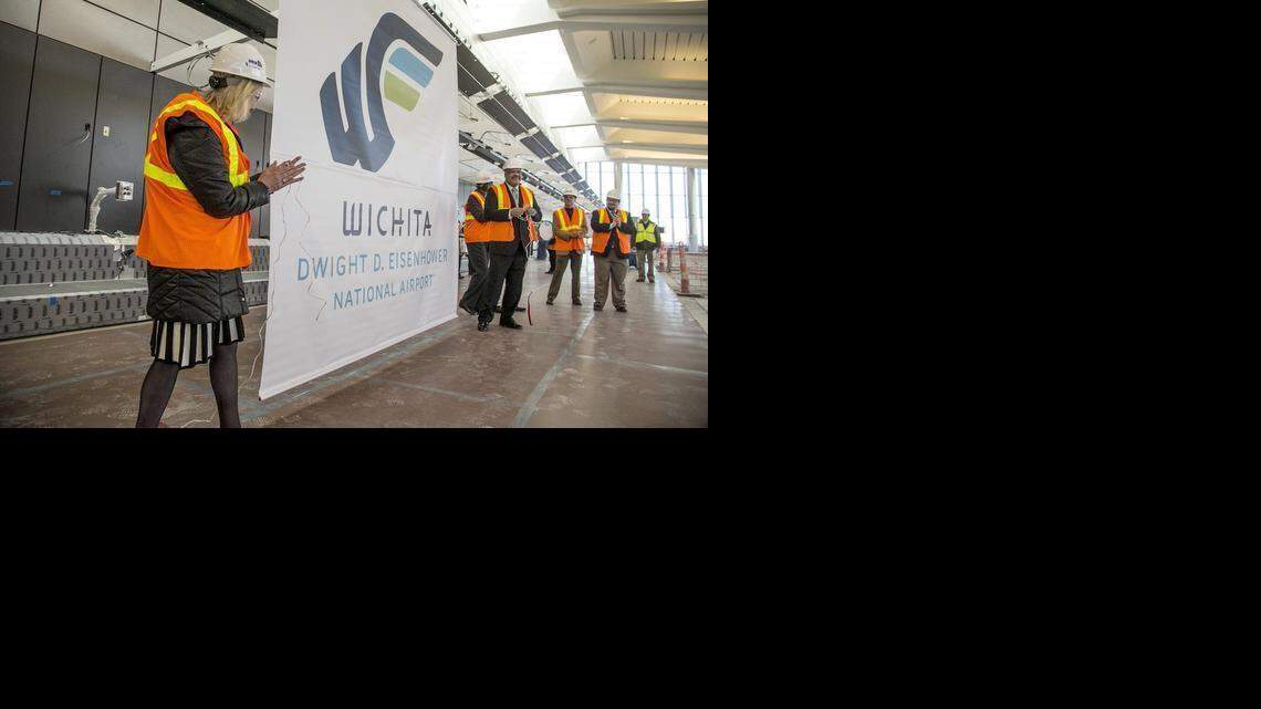 
Mary Eisenhower, granddaughter of Dwight D. Eisenhower, unveils the Wichita Dwight D. Eisenhower National Airport logo. Mayor Carl Brewer and Wichita City Council members are on the right. (Jan. 26, 2015)
