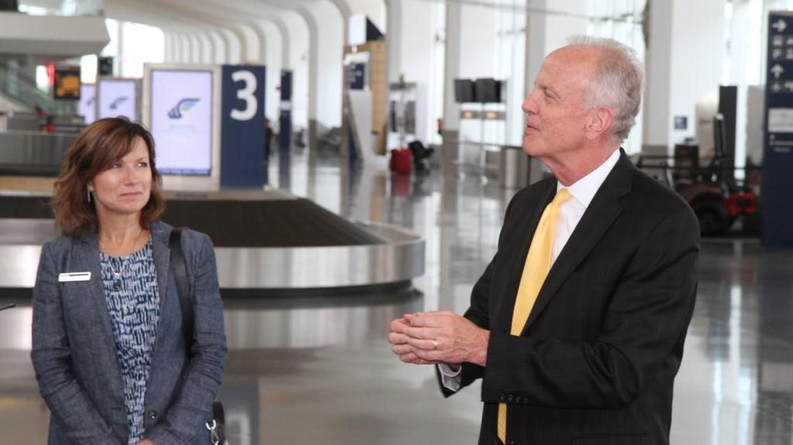 U.S. Sen. Jerry Moran, right, speaks during a tour Friday of Wichita Eisenhower National Airport. Peggy Deiter of Bombardier Learjet, left, was one of a half a dozen people representing different Wichita companies in the general aviation industry who toured the airport with Moran.