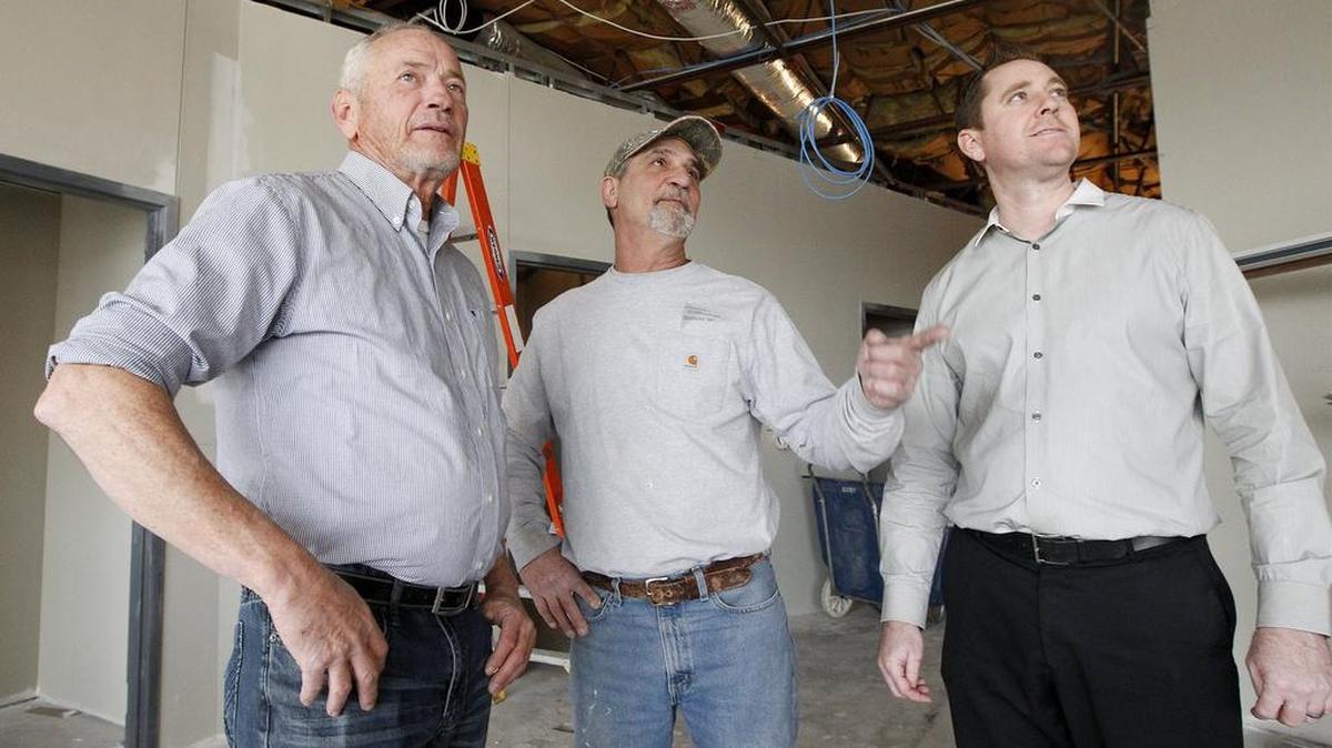 Dan Dopps, left, and his son, Rory Dopps, right, check out remodeling at the former HomeTown Buffet space on West Central with Commerce Construction superintendent Richard Welsh. Dopps Chiropractic is opening in the space next month. A retail outlet will follow, which Dan Dopps says he’ll share more information about later, and then there will be room for one more business at the 13,000-square-foot building.
