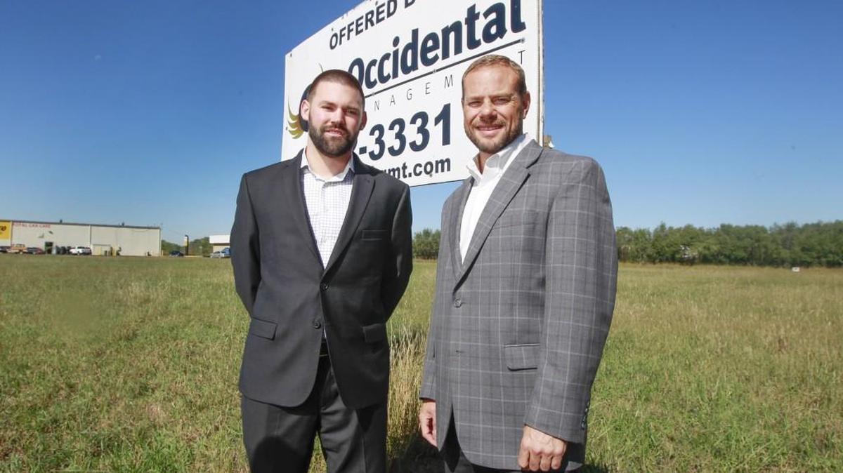 Occidental Management president Chad Stafford, right, and broker Charlie King stand in front of property just southeast of 34th and Woodlawn where a new 25,000-square-foot retail development will go. Harbor Freight Tools will be the first tenant with 15,000 square feet of space.