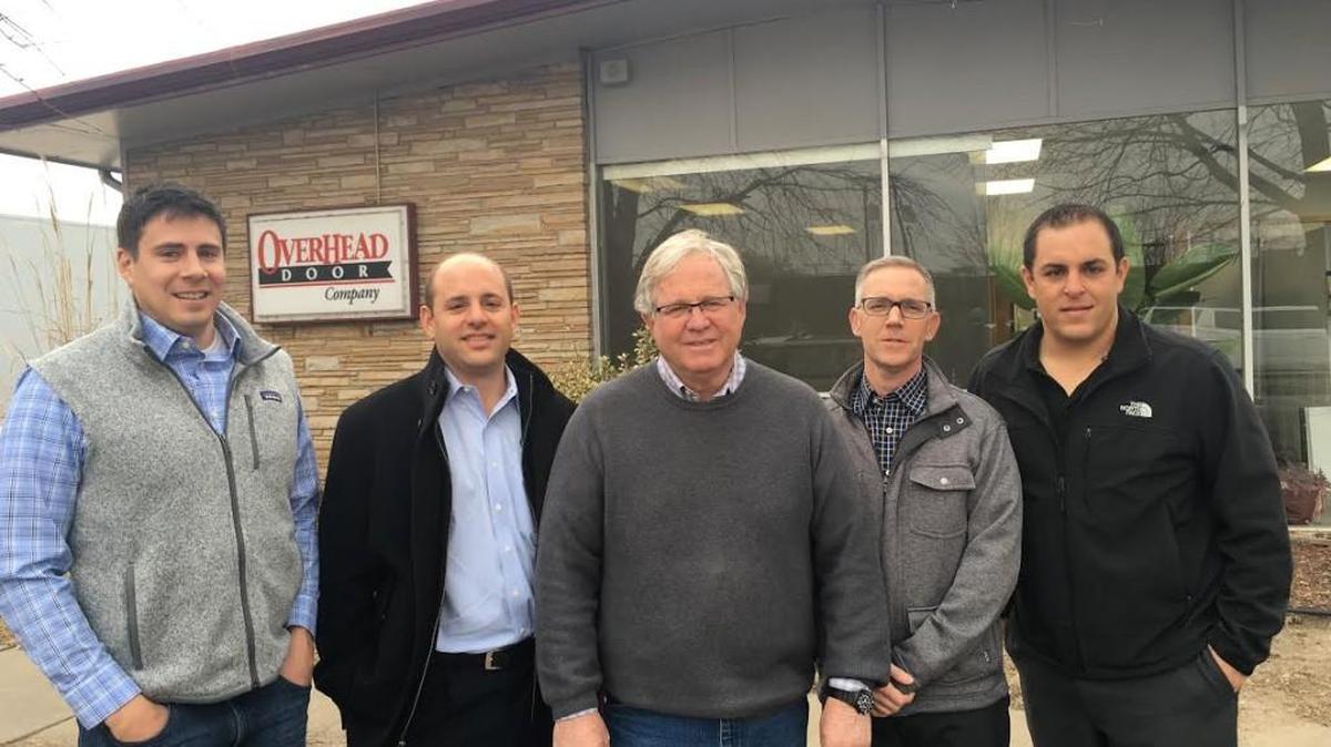 Mike Sweeney, center, has sold his Overhead Door and Aviation & Specialty Doors to, from left, Steve Rothwell, Tommy Steven, Chad Blackman and Zack Steven.