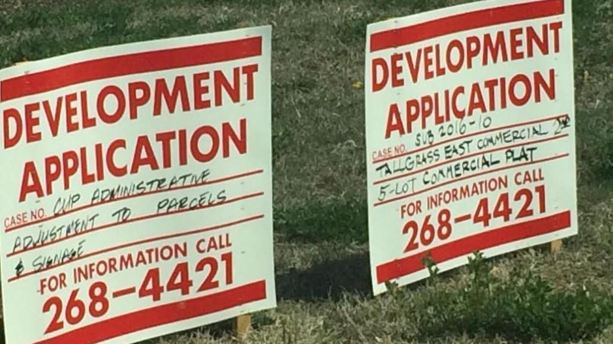 These development application signs are on a property along 21st Street just east of 21st and Webb Road where the new Opti-Life Center is proposed to open.