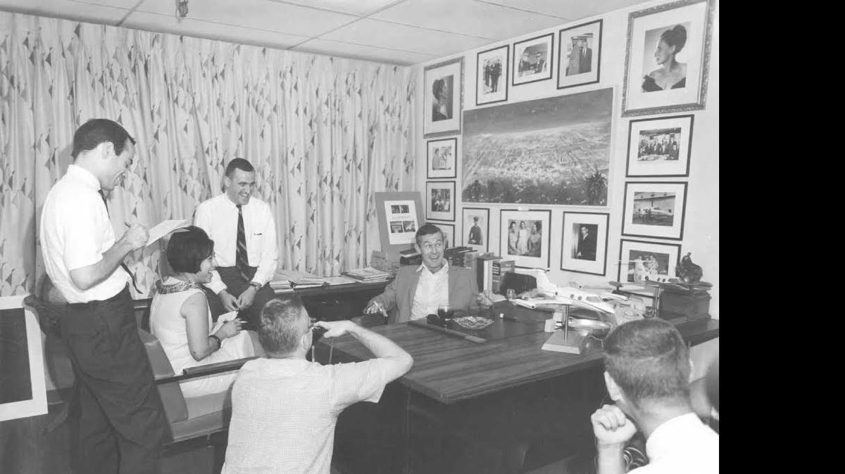 
Johnny Carson sitting at Bill Lear’s desk in 1965. Al Higdon is sitting on the credenza to his side.
