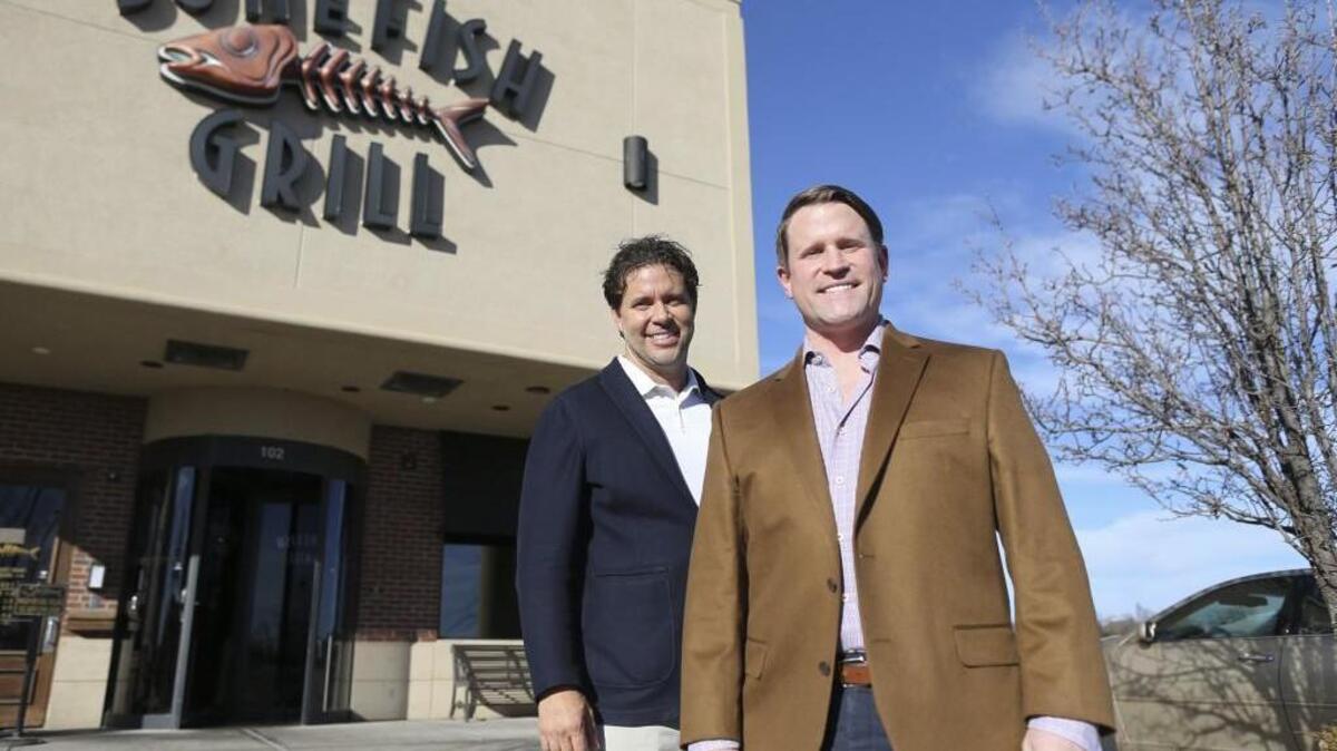 The Waterfront’s Stephen Clark II, right, and Landmark Commercial Real Estate broker Don Piros stand near where a new 17,000-square-foot retail center will be built at the Waterfront. Bassett Home Furnishings is the first tenant for the center and should open sometime in November.