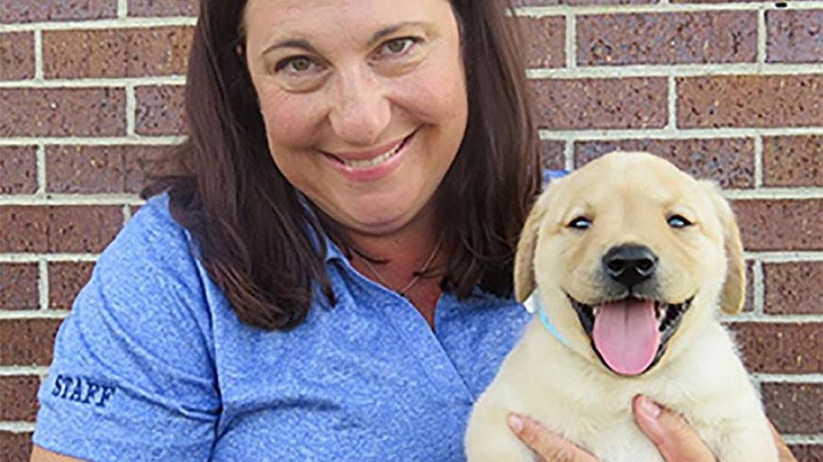 Julie Prater with Winslow, a future assistance dog at KSDS Assistance Dogs. This is Prater’s official photo for her business card as the new development director at KSDS.