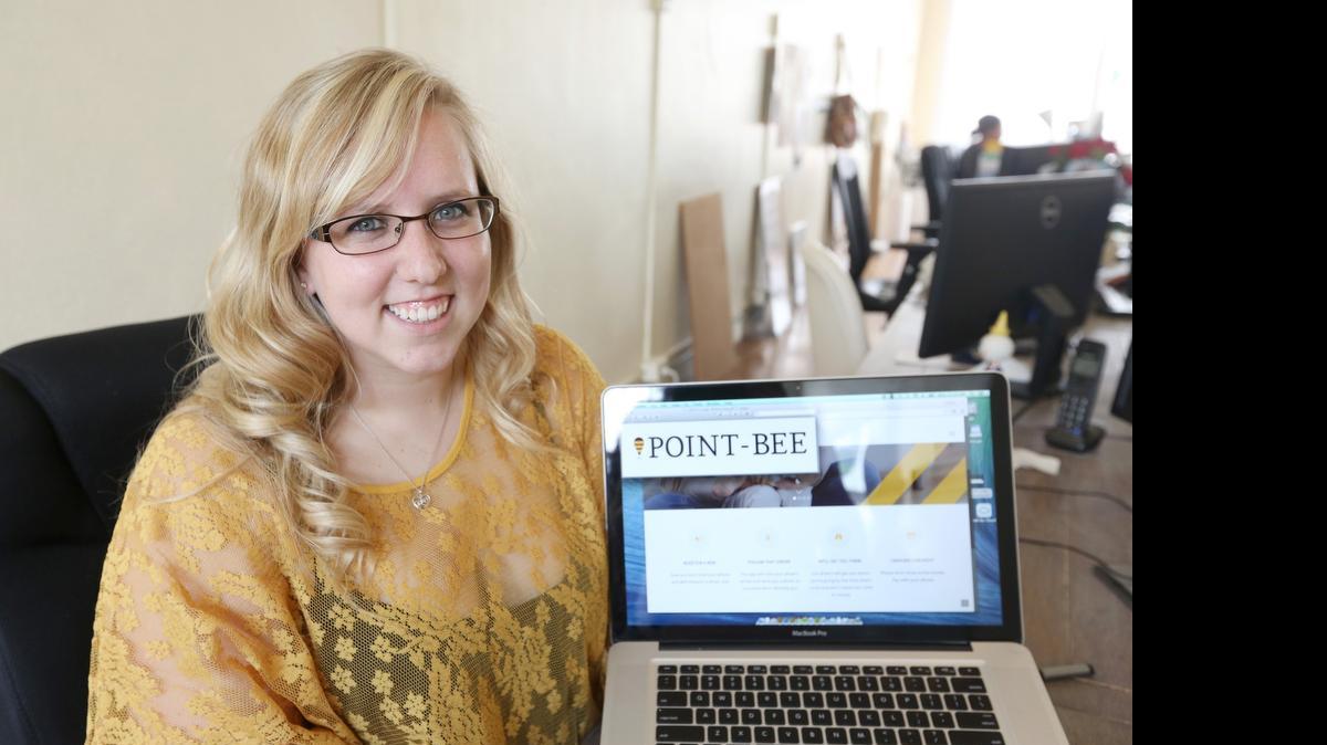 
Kristyn Smith, a senior designer at Baseline Creative, shows off the Point-Bee logo. It's a transportation alternative to taxi service and San Franciso-based Uber.
