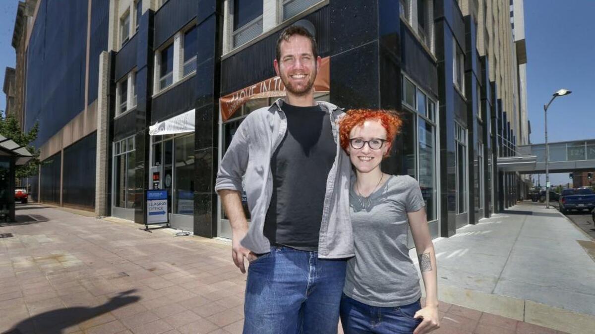 Thomas Koch, left, and Caitlin Doolittle stand in front of where they plan to open Sente, a new coffee bar and game room, in the Douglas at the northwest corner of Douglas and Market.