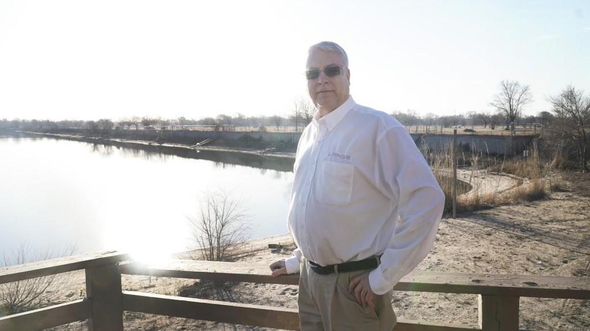 Real estate developer Jeff Lange stands at the lake at the new Steeple Bay development where Camping World and Gander Outdoors are going to open next year.