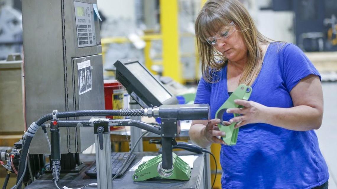 Tect Aerospace quality lead person Tonya Wallace marks airplane parts at the company’s facility in Park City on Tuesday.