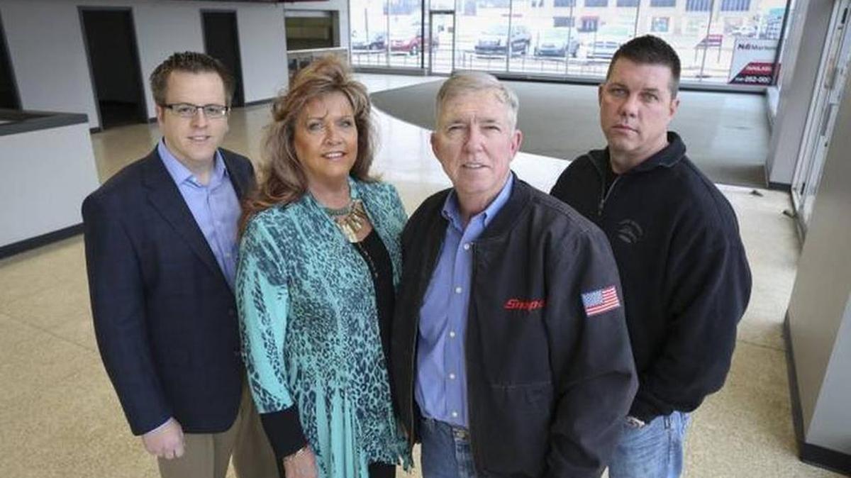 R.D. Wood, second from right, and his wife, B.J., purchased the former Big Dog Motorcycles showroom last year and leased it faster than expected. The Woods’ son, Zach, right, says the building’s location in the Douglas Design District is ideal. Kris Wessel, left, of NAI Martens represented the Woods family in the deal and has handled leasing at the space.