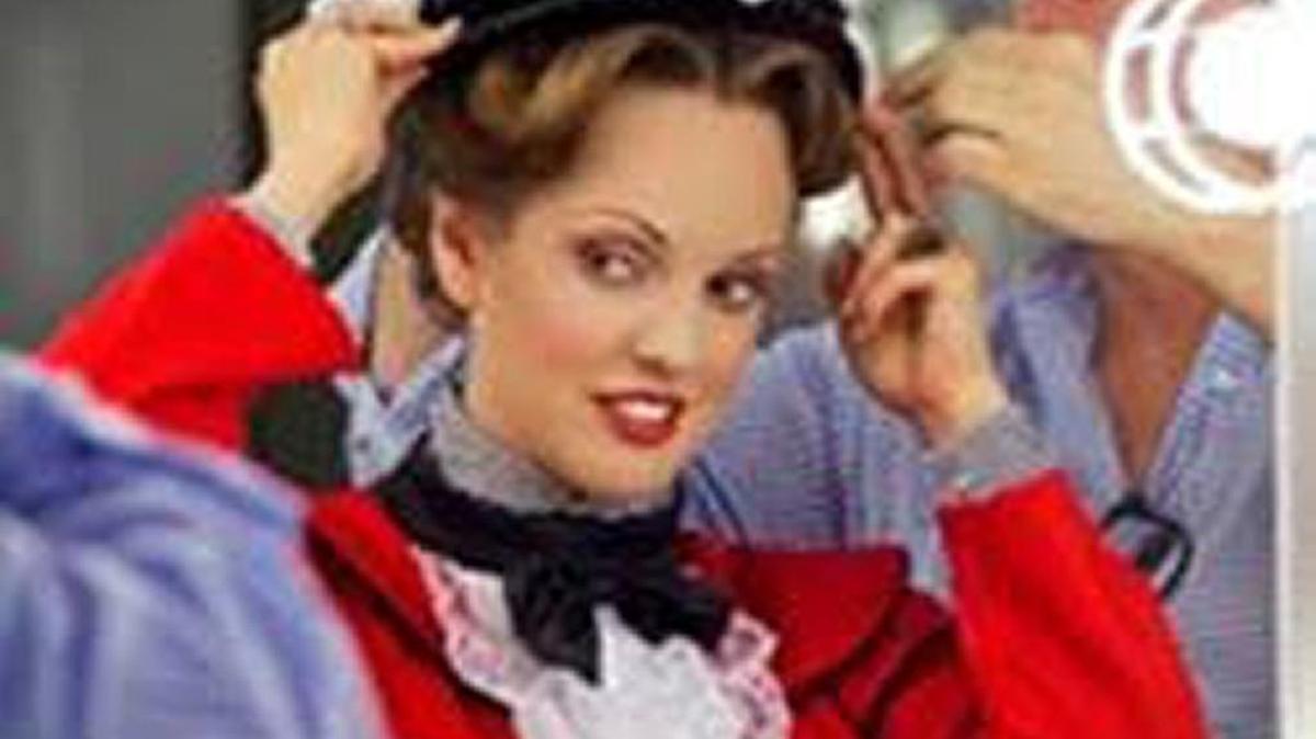 Jamey Varnadore makes an adjustment on a “Mary Poppins” costume.