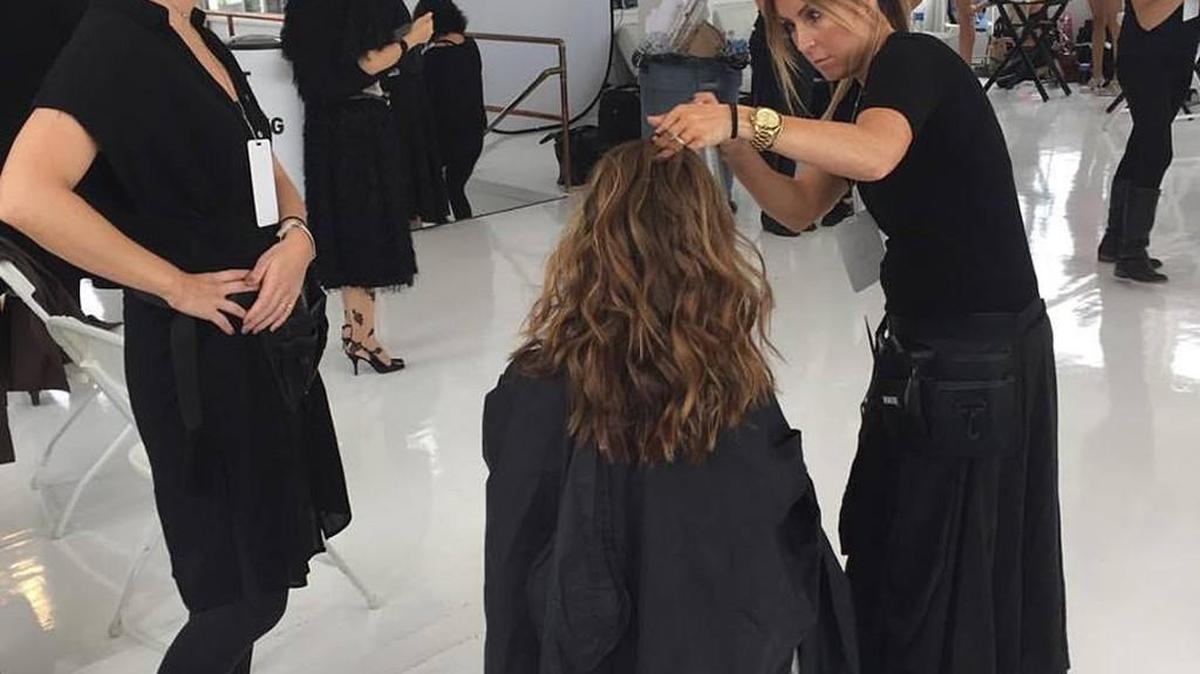 Libby Rivera, left, and Susan Brady work on a model during New York Fashion Week last week.