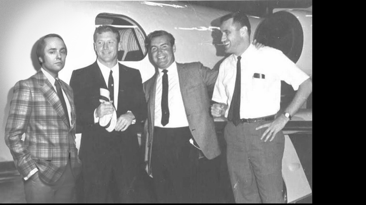 
Thanks to the creativity of Sullivan Higdon & Sink designer Devin Brown, “Mad Men” character Pete Campbell (left) joins real Mad Man Al Higdon (right), Tom Vickers (second from right) and Mickey Mantle in front of a Learjet in 1971.
