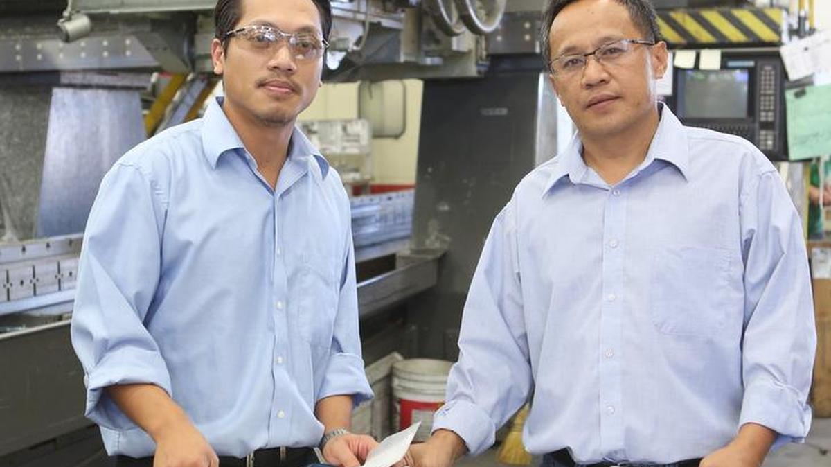 
Cang Phu, left, president, and production manager Tuan Lai are the owners of Quik Tek Machining. The company was named the Kansas Department of Commerce’s minority-owned manufacturer of the year for 2015.
