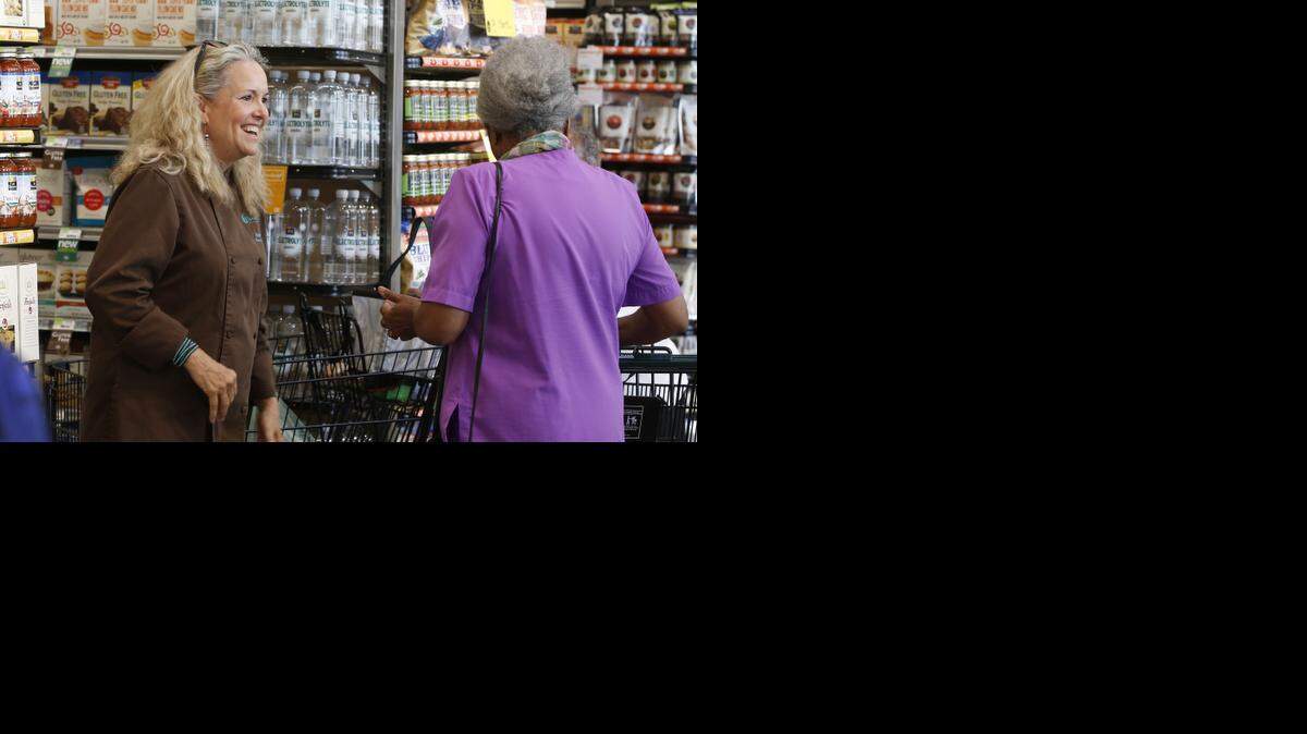 
Cocoa Dolce owner Beth Tully talks to customers while giving out samples of her chocolate during the official opening of Whole Foods Market Wednesday morning. The 30,900-square-foot store is the anchor tenant to the Waterfront Plaza on the northwest corner of 13th and Webb. (September 3, 2014) 
