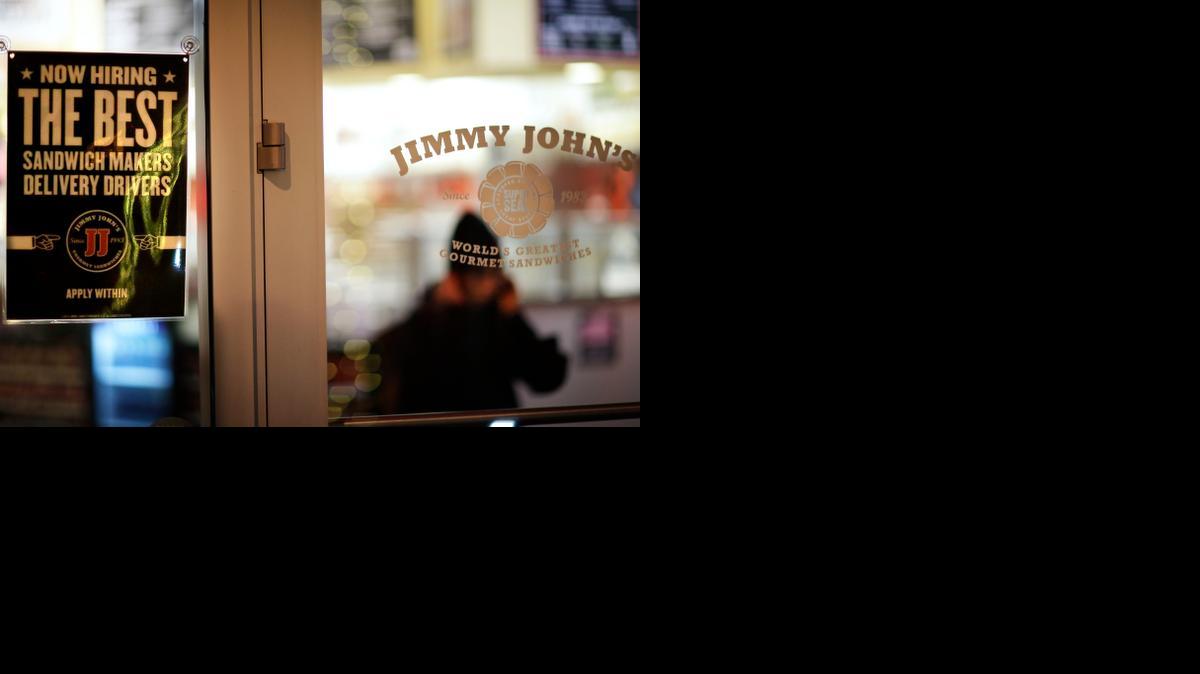 
A sign advertises hiring opportunities at a Jimmy John’s sandwich shop, as an employee walks out to make a delivery earlier this month in Atlanta. A lawsuit targeting the fast-food sandwich chain raises the issue of how noncompete agreements are used by businesses in the U.S.

