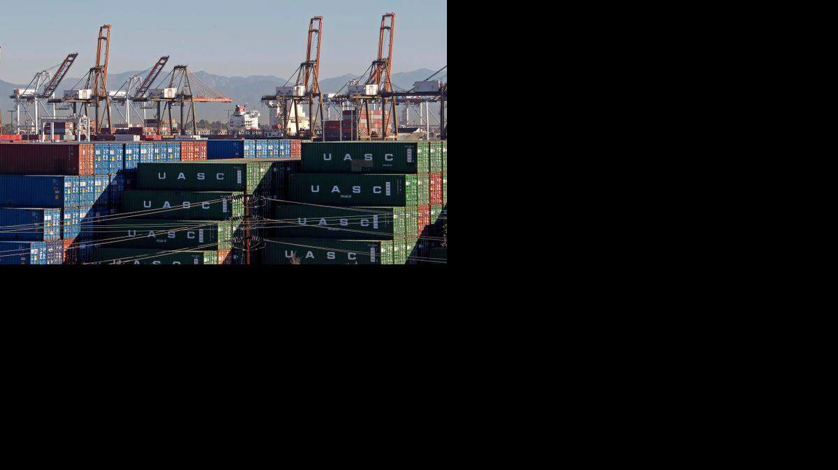
The Ports of Los Angeles and Long Beach, with some cargo loading cranes in the upright and idle position, are seen in this view from the San Pedro area of Los Angeles Thursday. Seaports in major West Coast cities that normally are abuzz with the sound of commerce are falling unusually quiet. Companies that operate marine terminals said they weren't calling workers to unload ships through much of the next five days. 
