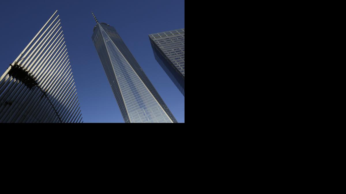 
One World Trade Center stands between the transportation hub, left, still under construction, and 7 World Trade Center, right, Monday, Nov. 3, 2014 in New York. Thirteen years after the 9/11 terrorist attack, the resurrected World Trade Center is again opening for business, marking an emotional milestone for both New Yorkers and the United States as a whole. Publishing giant Conde Nast will start moving Monday into One World Trade Center, a 104-story, $3.9 billion skyscraper that dominates the Manhattan skyline. 
