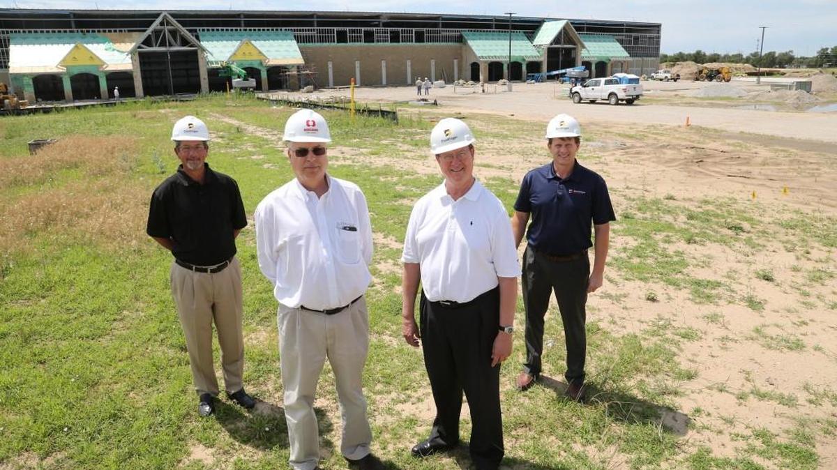 From left, Philip Meyer, Jeff Lange, Tom Dondlinger and Eric Swenson stand at Lange’s new IronHorse Manufacturing Park on South Seneca near MacArthur.