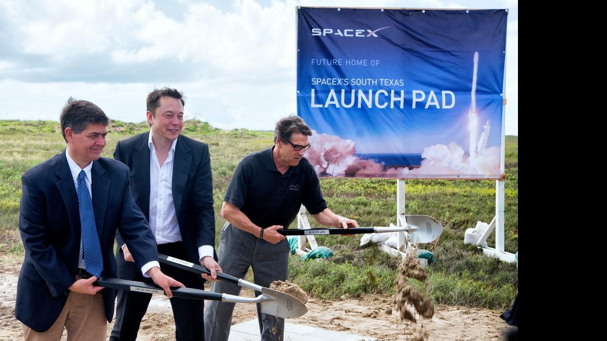 
U.S. Rep. Filemon Vela, left, SpaceX founder and CEO Elon Musk, center, and Texas Gov. Rick Perry turn the first shovel-full of sand at the groundbreaking ceremony for the SpaceX launch pad at Boca Chica Beach, Texas, in September 2014. The SpaceX venture, led by PayPal co-founder and electric car maker Musk, is one of two players in a Texas-style, 21st-century space.
