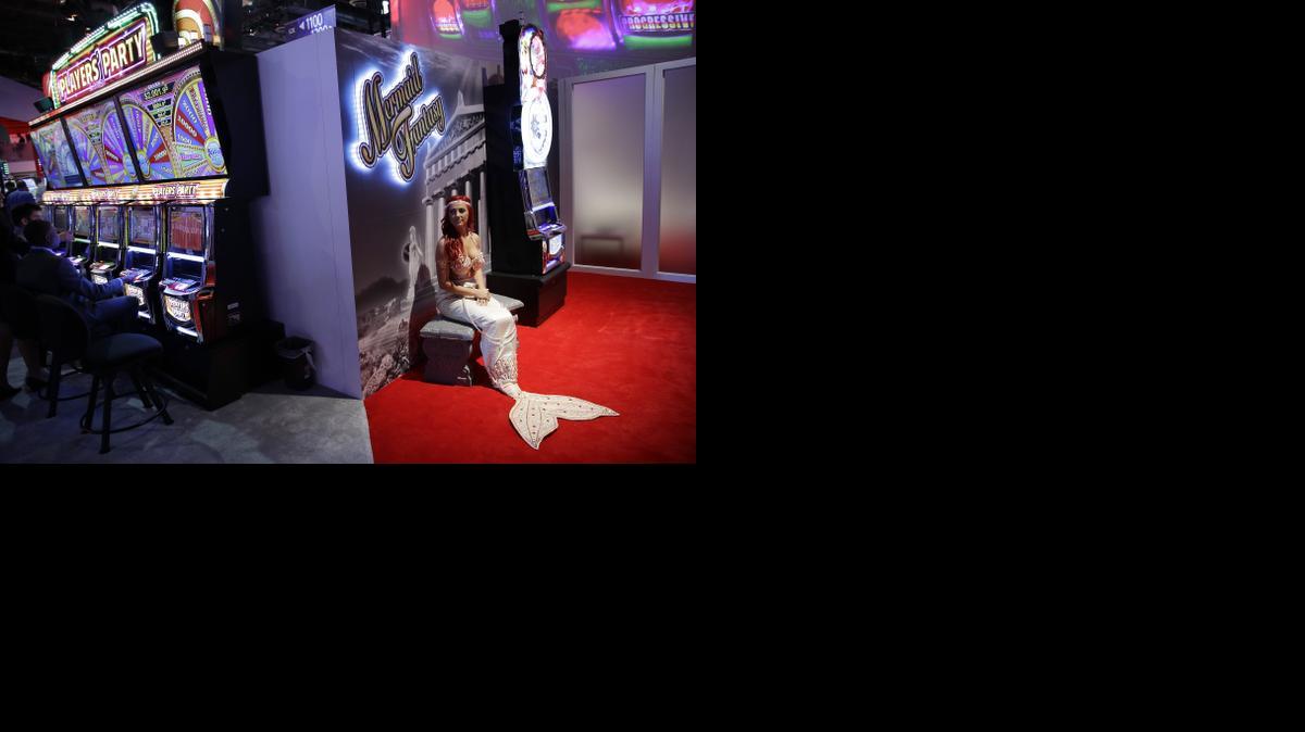 
Samantha Whittemore wears a mermaid costume at the Aruze booth during the Global Gaming Expo on Tuesday in Las Vegas. U.S. casinos and the makers of the games found inside had a $240 billion economic impact and employed 1.7 million people in 2013, a study shows. 
