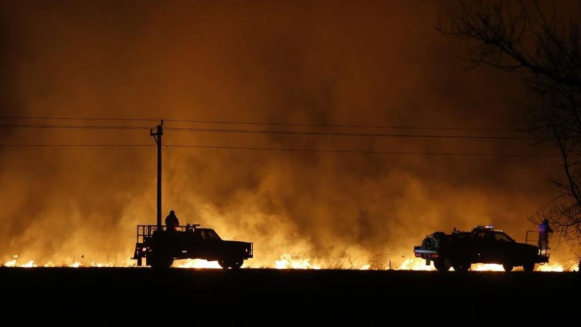 Firefighters from across Kansas and Oklahoma battle a wildfire near Protection last week. The fire driven by winds gusting up to 50 mph threatened Protection and Ashland.