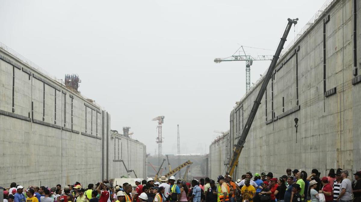
People walk inside the expanded Panama Canal’s new set of locks before they are flooded, in Cocoli, near Panama City, Sunday, May 17, 2015. The construction of the third set of locks will allow the passage of very large vessels or container ships much too big to fit through the Panama Canal’s old locks.
