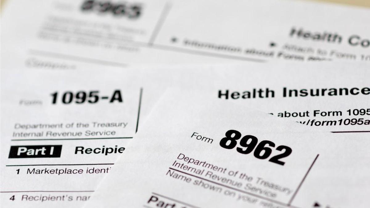 FILE - In this Aug. 21, 2014 file photo, health care tax forms 8962, 1095-A, and 8965, are seen in Washington. The Obama administration says it’s giving employers who need more time a limited extension for critical reporting requirements next year under the federal health care law. The Treasury Department said Monday it acted after many employers complained they might not be able to get information processed in time.