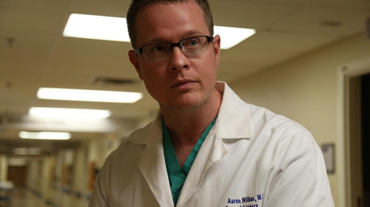 Aaron Nilhas, 30, has spent 80 hours a week for four years training to be a surgeon and has one more year left. He’s from a small town in Kansas and wants to stay in Kansas to practice.