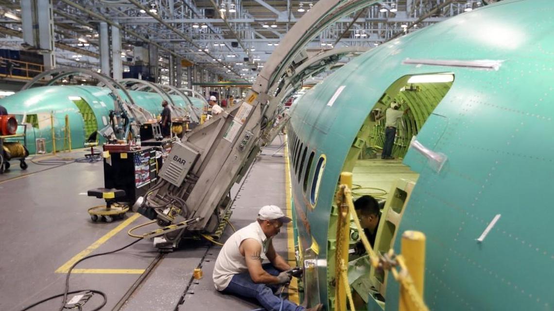 Spirit AeroSystems employees work on a 737 in 2014.