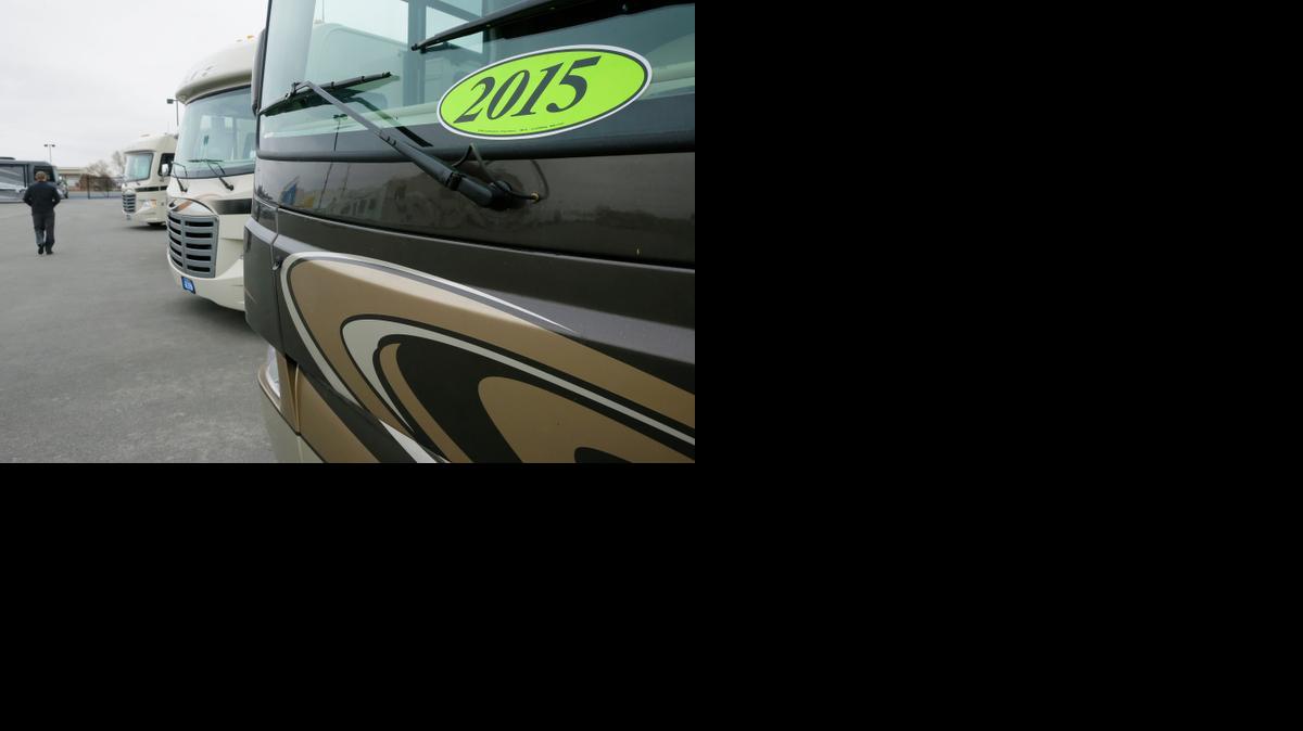 
A man walks past a row of 2015 motor homes at Camping World RV Sales in North Little Rock, Ark., Tuesday. Production of motor homes is expected to return next year to levels seen before the recession.
