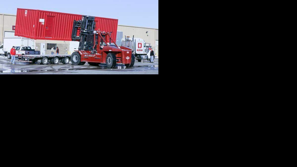 
Workers load a Red Guard building onto a truck that will be shipped to Canada at their factory in south Wichita last year. The structures are used as blast resistant housing and offices for refineries and chemical plants in Canada as well as the U.S. and other countries. 
