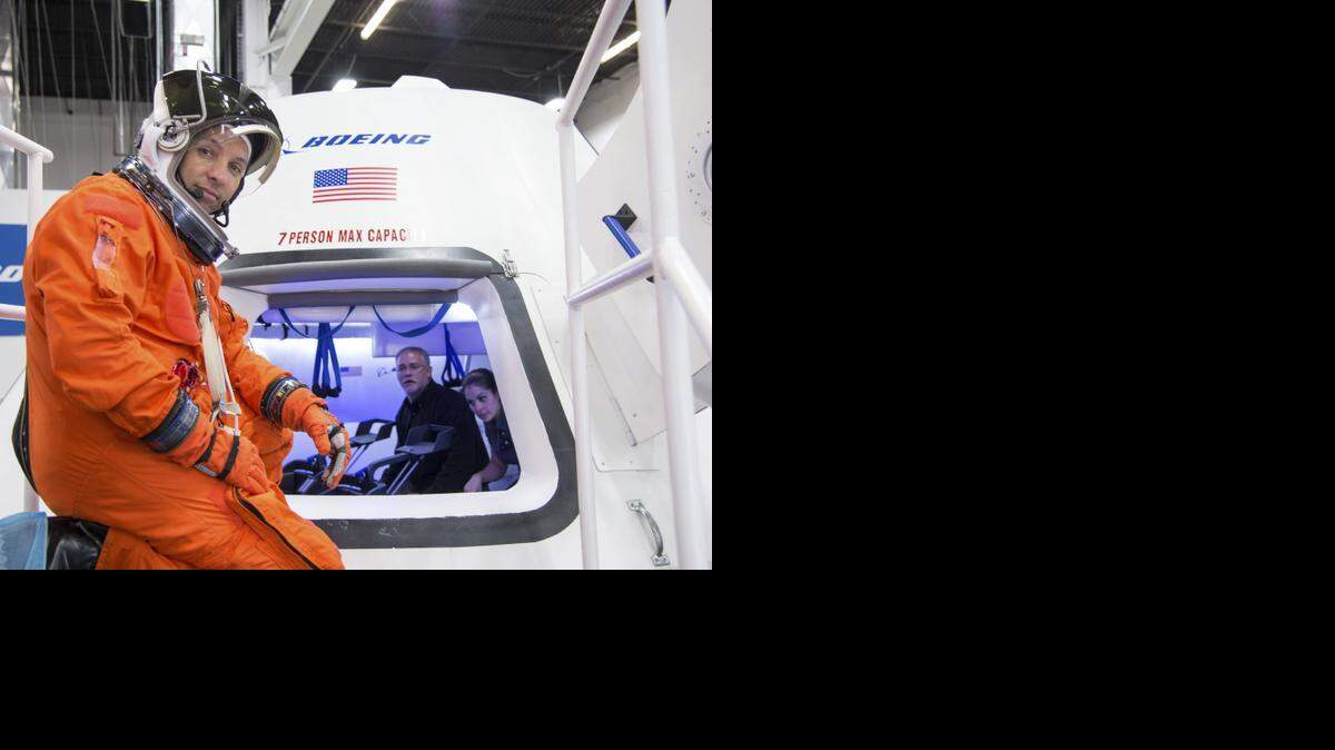 
In this undated image provided by NASA, astronaut Randy Bresnik prepares to enter The Boeing Company's CST-100 spacecraft for a fit check evaluation at the company's Houston Product Support Center. On Tuesday, NASA announced SpaceX and Boeing will get NASA contracts to transport astronauts to the International Space Station. The deal will end NASA's expensive reliance on Russian crew transport.

