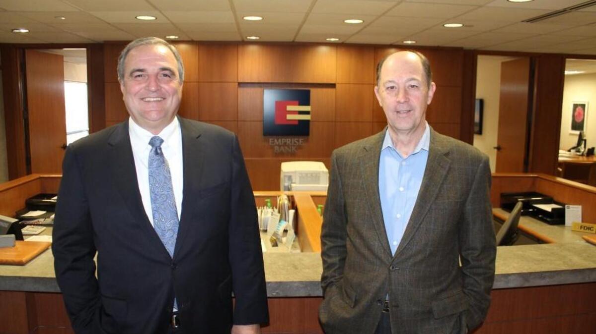 Emprise Bank president and CEO Tom Page, left, pictured with retired Emprise chairman M.D. “Mike” Michaelis in 2013.