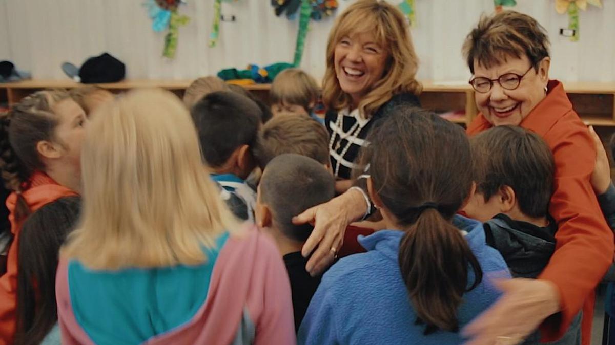 Jeanine Phillips, left, and Gretchen Andeel greet children at the Fundamental Learning Center in Wichita. The two received the annual humanitarian of the year award this week for their work with dyslexic children from the Small Business Council.