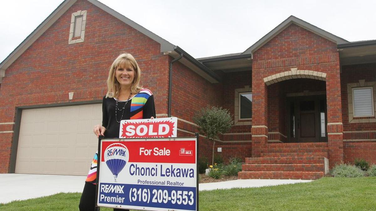
Realtor Chonci Lekawa, shown Monday with a recently sold house in west Wichita, says new rules will be a welcome addition to the home-buying process.
