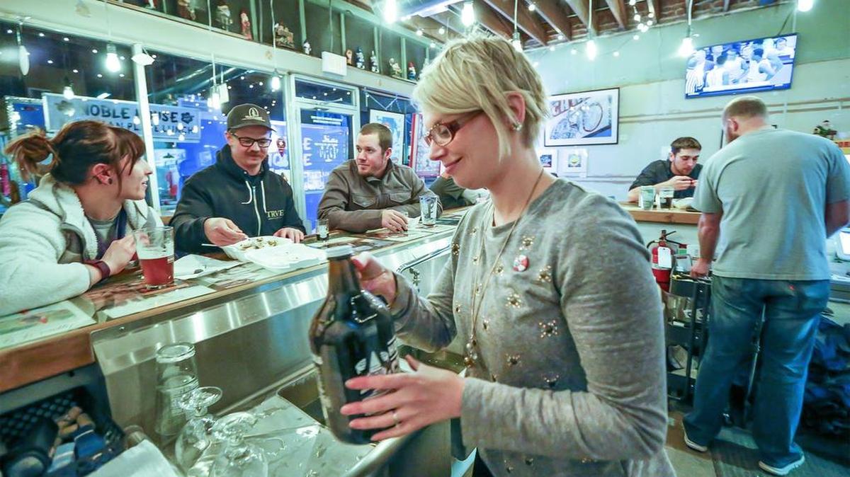 Stacy Ward-Lattin, co-owner of Hopping Gnome Brewing Company, serves customers in 2016.