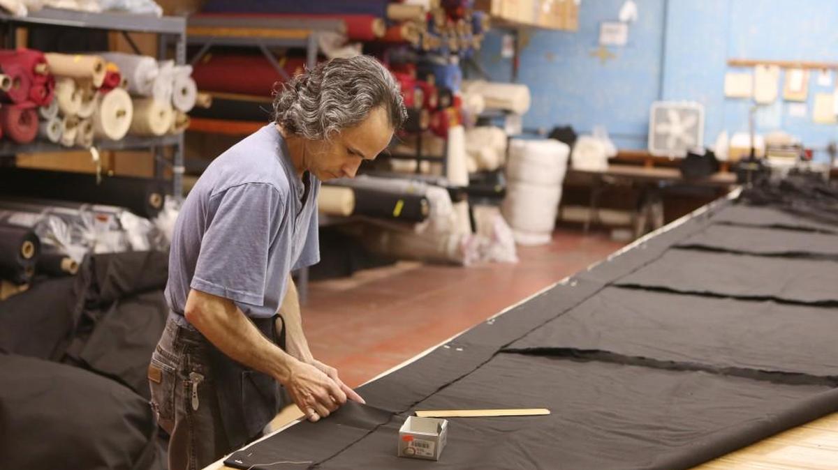 Pat Darrah works on a custom valance at Theatrical Services, a business that rents lights, makeup, curtains, props, etc. for theatrical performances. (Nov. 2, 2015)
