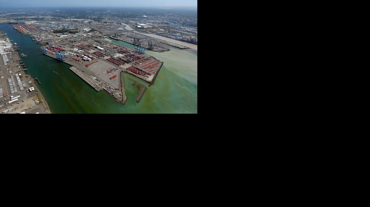 
In this photo taken in July, cargo container facilities at the Port of Tacoma are shown. The management team that administers the Tacoma port and the labor union that represents most workers at West Coast ports have been locked in a long dispute that has dirupted the shipment of goods in and out of the U.S.
