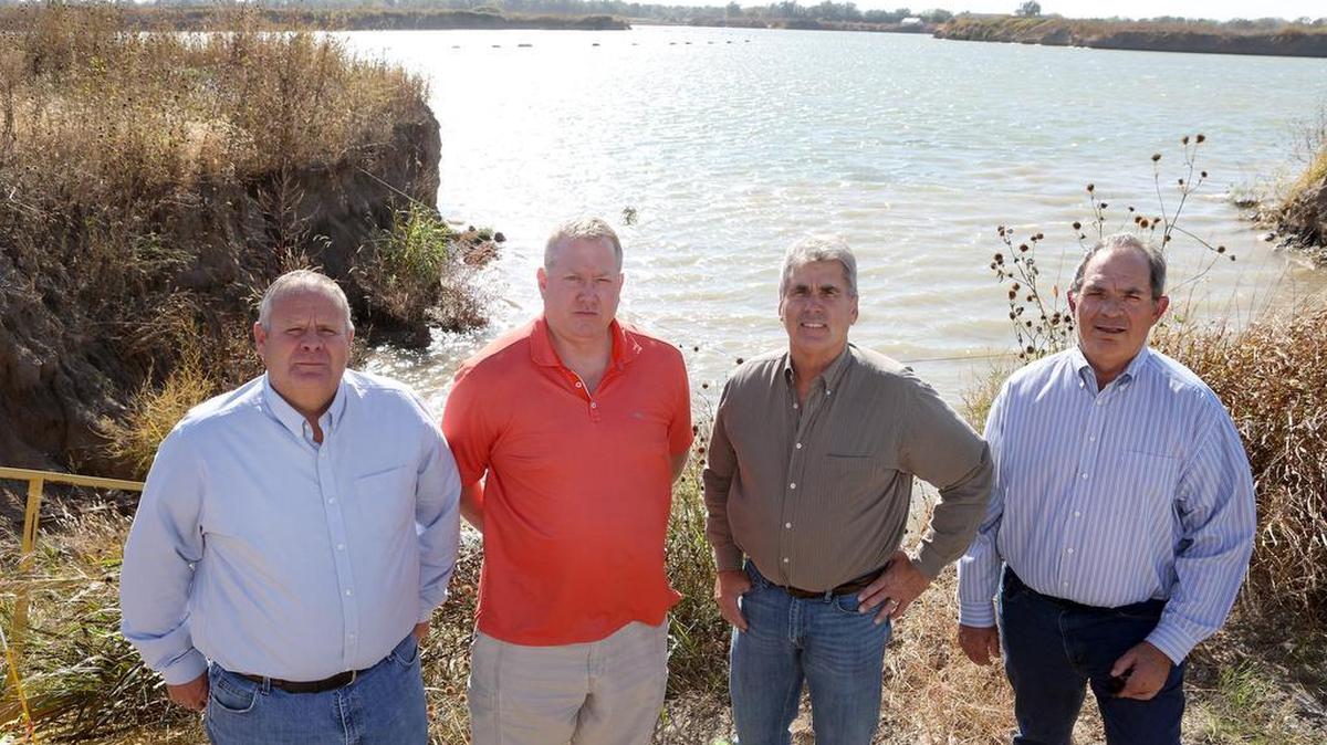 Real estate developer Jay Russell and homebuilders Randy Harder, Craig Sharp and Steve Robl are putting houses in an area of Wichita that has largely been neglected: the three miles straight north of the Sedgwick County Zoo between the Big Ditch and Ridge Road. The sandpit being dredged behind them will soon become the Pearl Beach housing development. (Oct. 20, 2015)