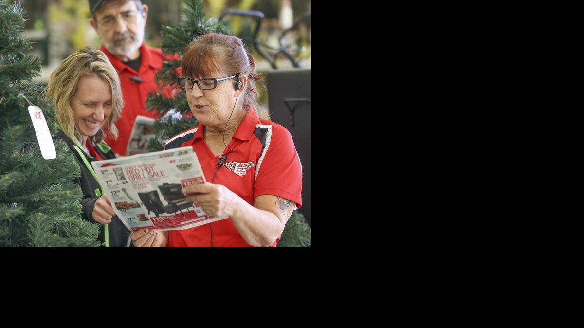 
Ace employees Cathy Owens, right, Kristle Wert, left, and Larry Vlin, rear, check out a sale flier for a customer Wednesday. (Nov.19, 2014)

