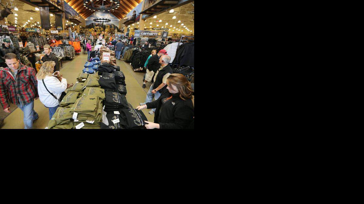 
Racks and tables of discounted items greet shoppers at the Wichita Cabela’s on Black Friday of 2013. 
