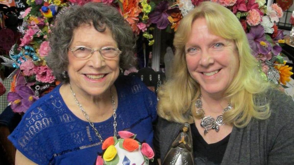 Jamal Bara, right, and her mother, Fran Elliott, hold some of the wares for sale at Secret Sugar Skull Shack, the gift shop Bara owns in Riverside.