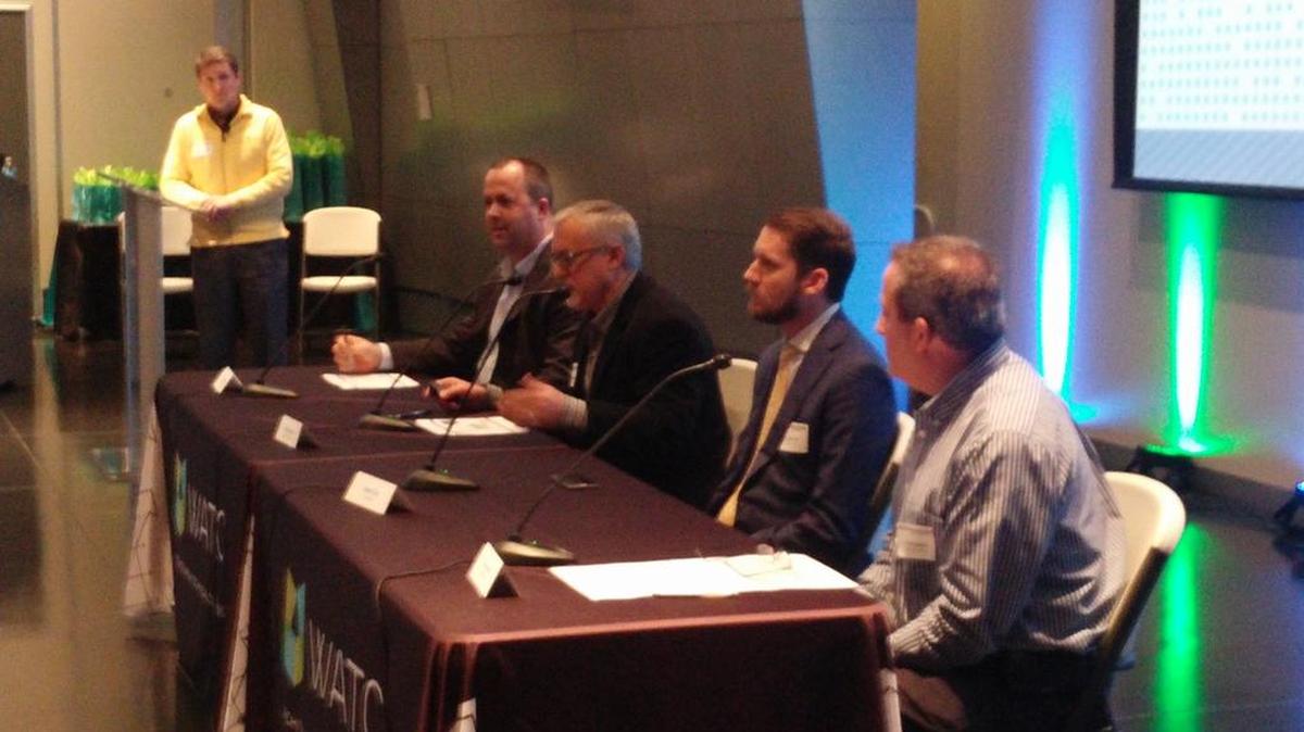 Nick Messer of Millennium Manufacturing, center, speaks at the Advanced Manufacturing Forum on Tuesday. From left are Curtis Richardson, standing, David May, Messer, Jason Cox and Tom Martin.