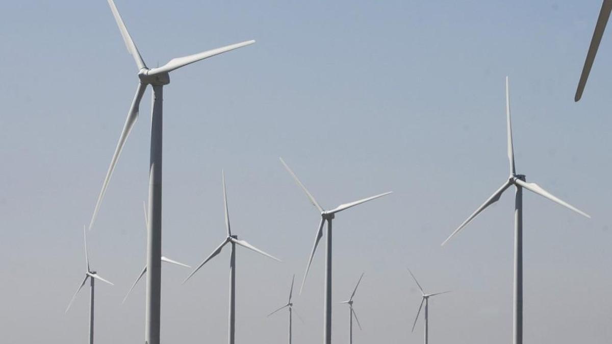 Wind turbines line up across the horizon south of Nashville in south-central Kansas.