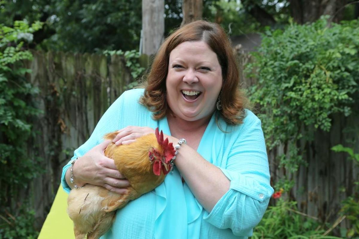 Wichita Eagle business columnist Carrie Rengers holds her chicken Gertie, who apparently actually is a rooster.