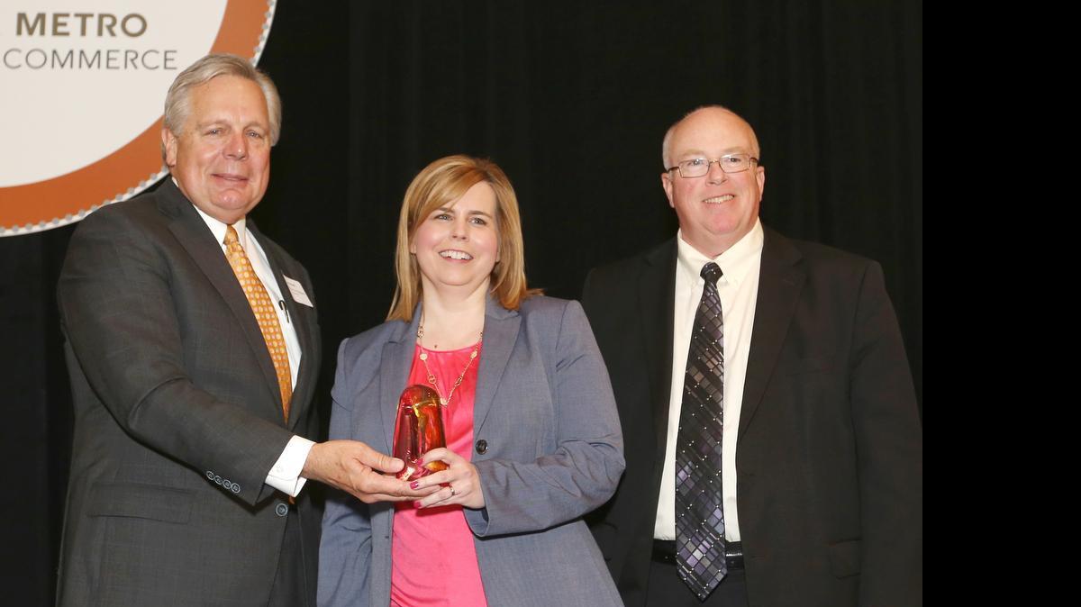 
Jon Rosell, left, executive director of the Medical Society of Sedgwick County and Wichita Metro Chamber of Commerce chairman, and Gary Plummer, president and CEO of the chamber, present Joy Eakins, owner of Cornerstone Design, with an award Wednesday during the Wichita Metro Chamber of Commerce Small Business Awards. (May 13, 2015)
